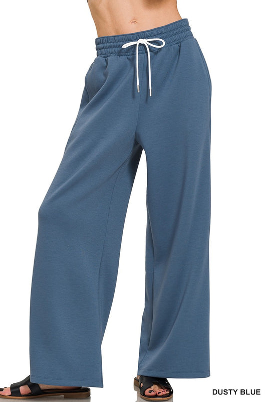 Dusty blue pants with a drawstring on a white background