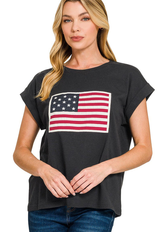 Woman wearing a black t-shirt with an American flag design on a white background