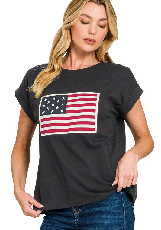 Woman wearing a black t-shirt with an American flag design on a white background