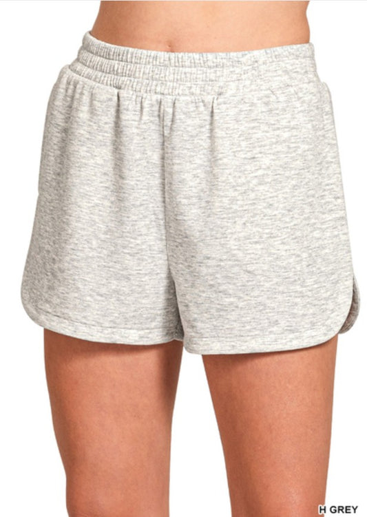 Gray shorts worn by a person on a white background