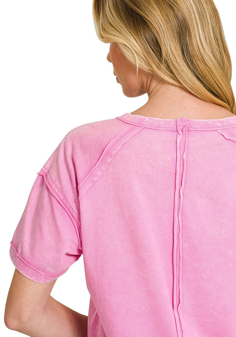 Back view of a woman wearing a mauve top on a white background