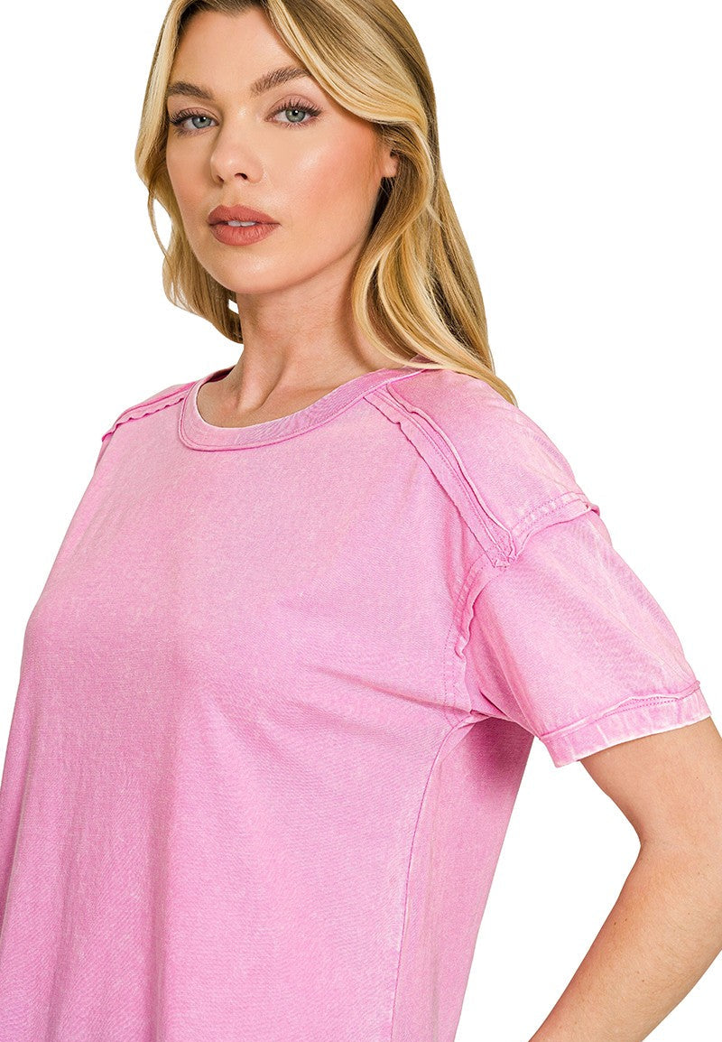 Woman wearing a mauve top with a white background