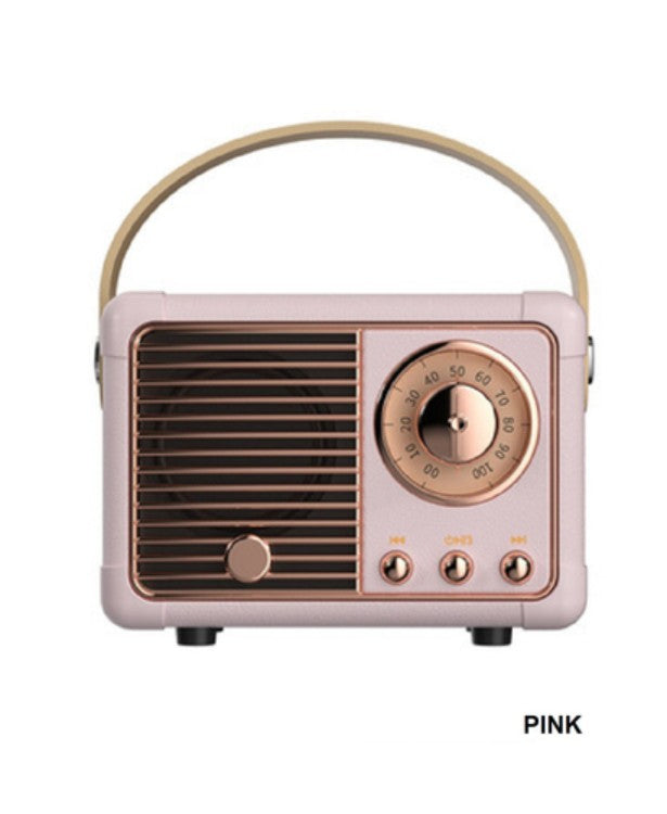 Vintage-style radio with a pink body and gold accents on a white background