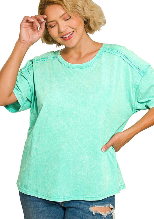 Woman wearing a mint green top on a white background