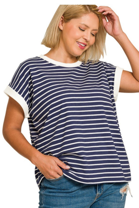 Woman wearing a navy and white striped t-shirt with blue jeans on a white background