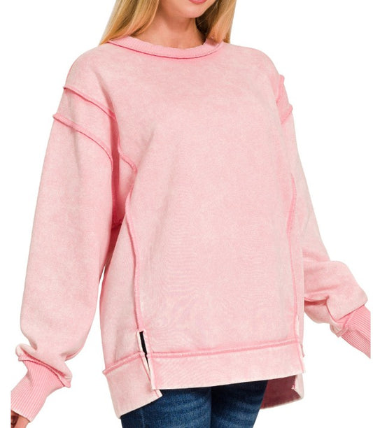 Pink sweatshirt worn by a person on a white background