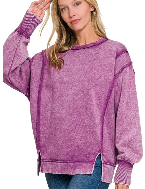 Woman wearing a purple fleece top on a white background