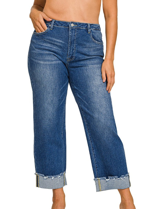 Blue jeans with rolled-up cuffs on a white background
