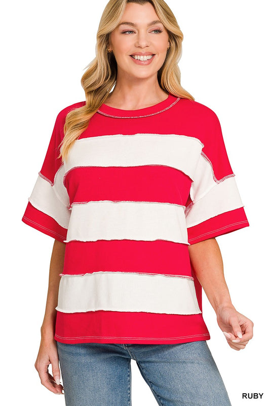 Woman wearing a red and white striped shirt with blue jeans on a white background
