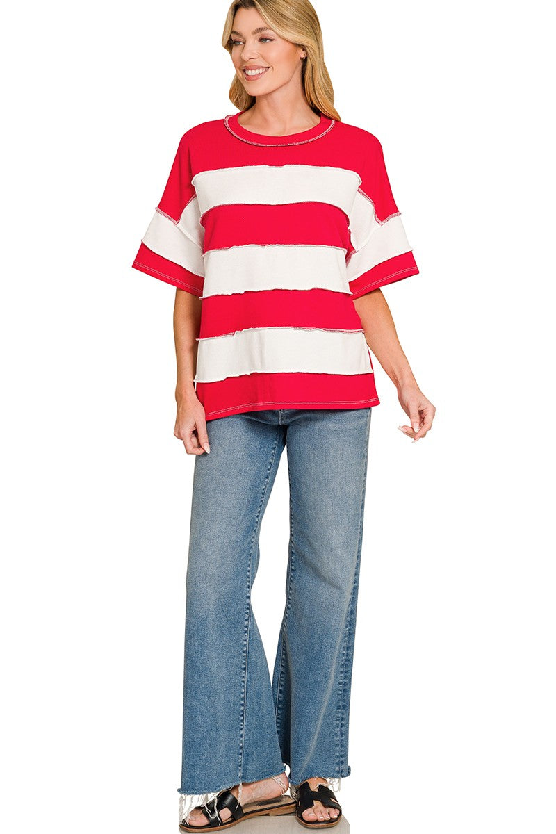Woman wearing a red and white striped shirt with blue jeans on a white background