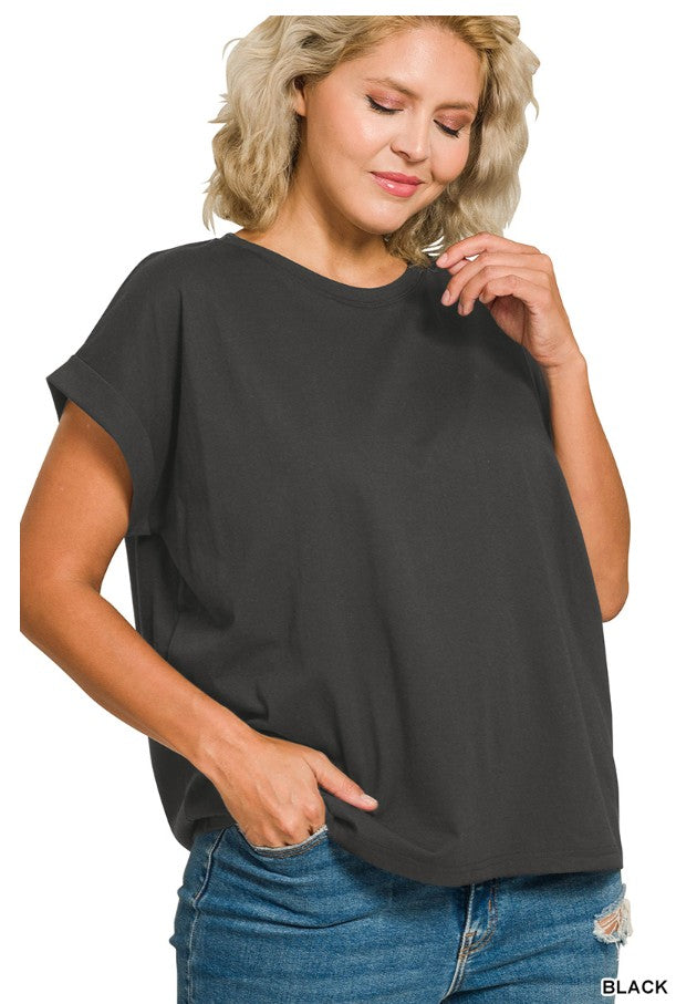 Woman wearing a black oversized t-shirt and blue jeans on a white background