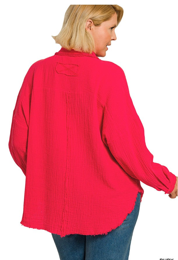 Person wearing a bright pink textured blouse with long sleeves on a white background