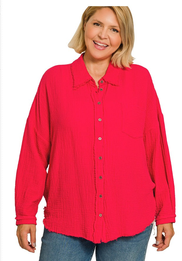 Woman wearing a red button-up shirt on a white background