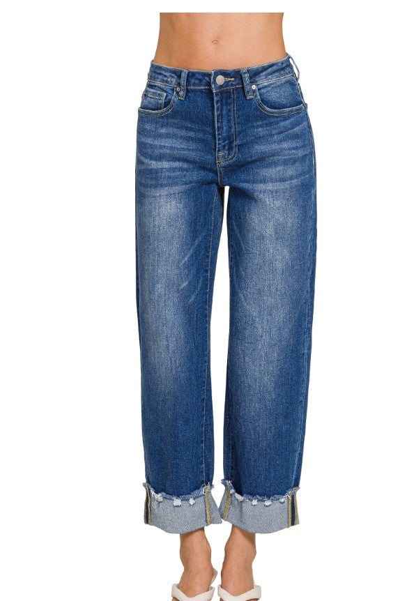 Blue jeans with rolled-up cuffs on a white background